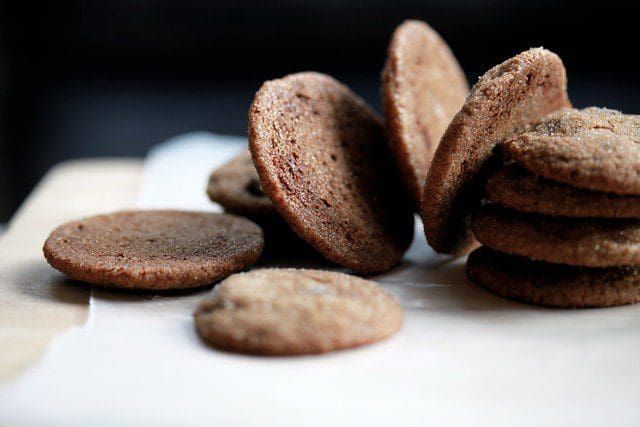 a pile of cookies sitting on top of a white cutting board next to each other