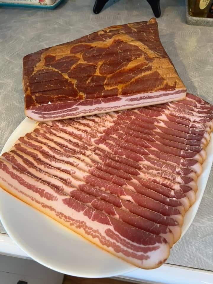 two large pieces of meat sitting on top of a white plate next to each other