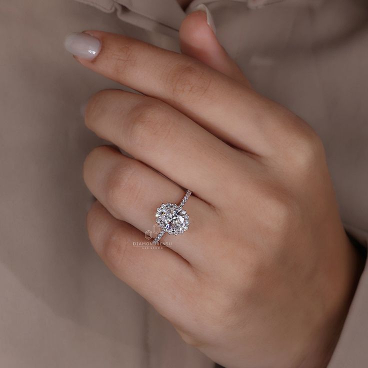 a woman's hand with a diamond ring on it