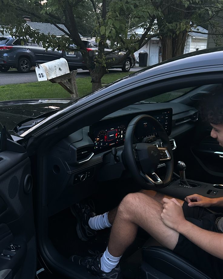 a man sitting in the driver's seat of a car