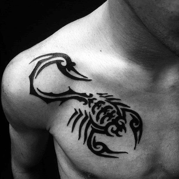 a black and white photo of a man's chest with a scorpion tattoo on it