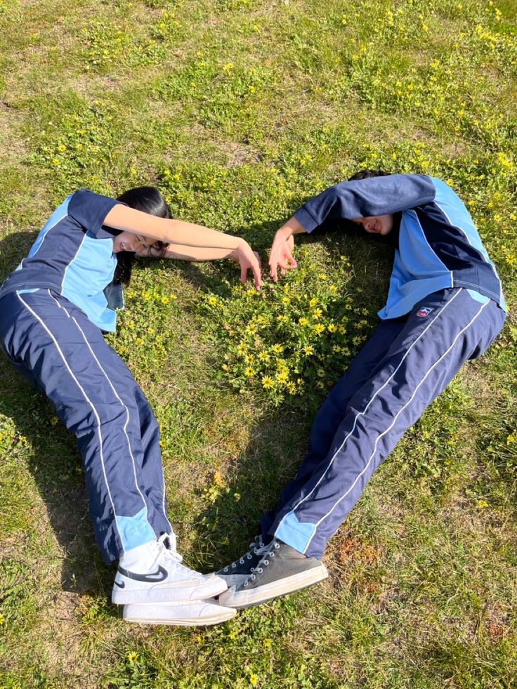 a man laying in the grass with his hands on his chest