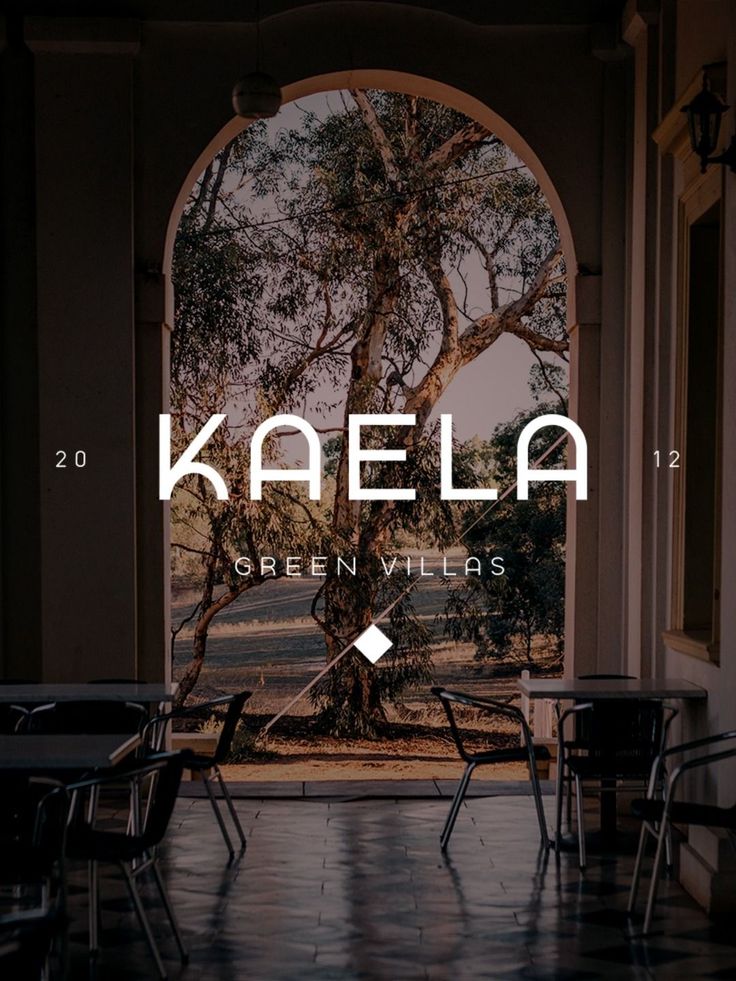 an open door with the words kalea on it in front of a table and chairs