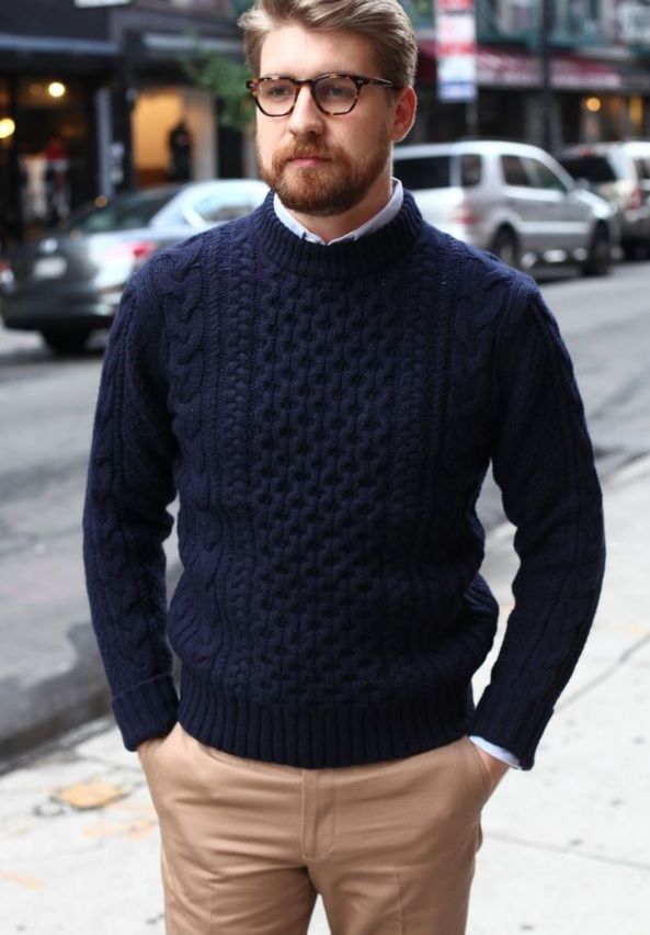 a man standing in front of a street with cars