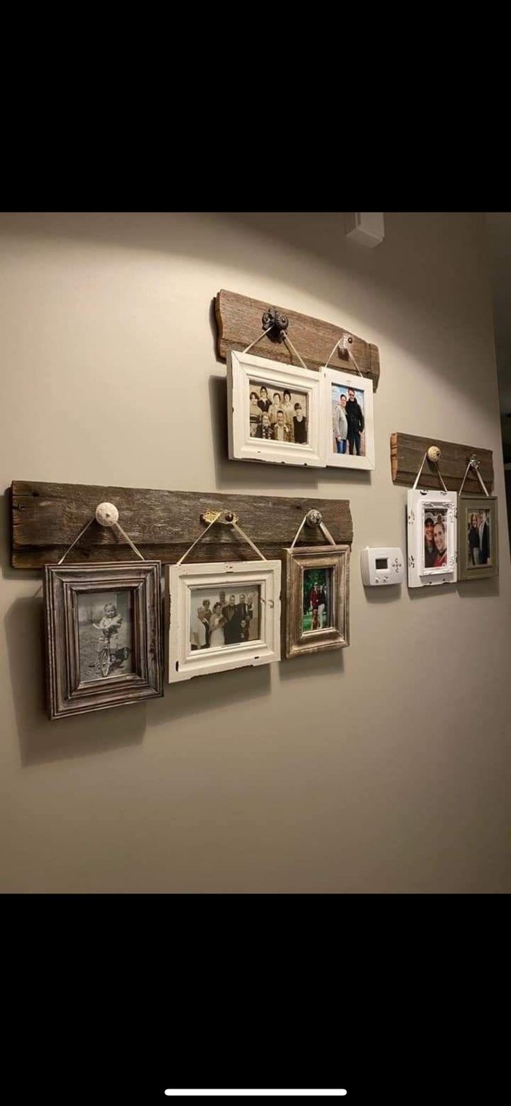 several frames are hanging on the wall with clothes pins and magnets attached to them