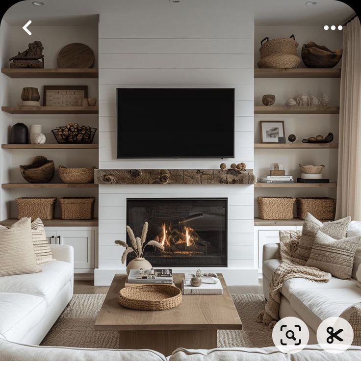 a living room filled with furniture and a flat screen tv mounted on the wall above a fire place