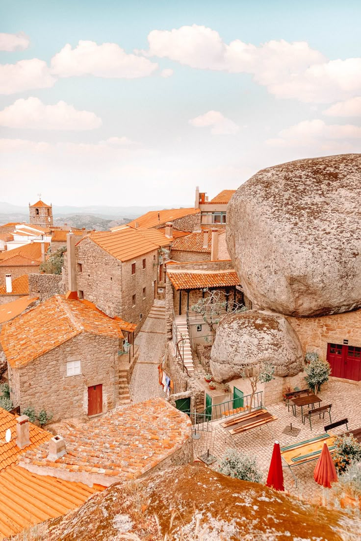 an aerial view of some buildings and a large rock