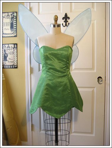 a green fairy costume on display in front of a door