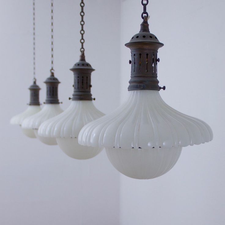 three light fixtures hanging from a ceiling in a room