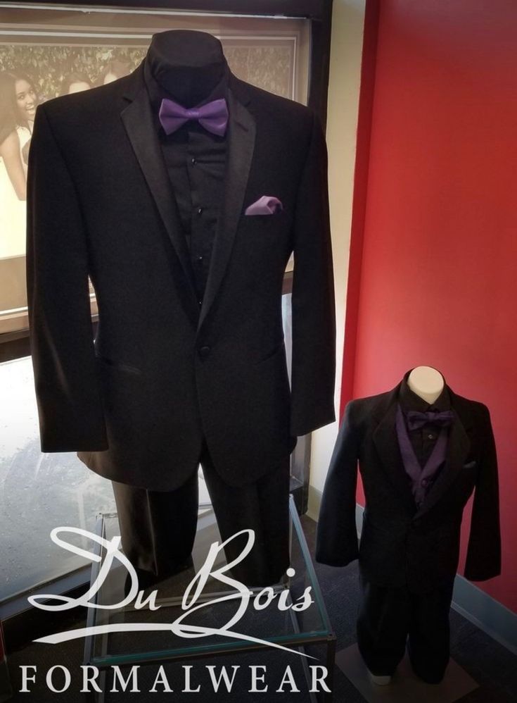 a suit and tuxedo are on display in a museum case with the words du bois formal wear