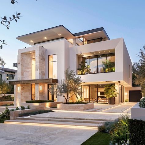 a modern house with stairs leading up to the front door and landscaping on both sides