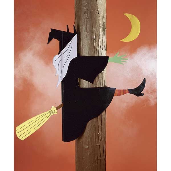 a painting of a witch on a telephone pole