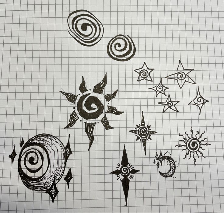 some drawings that are on top of a piece of paper with circles and stars in the middle