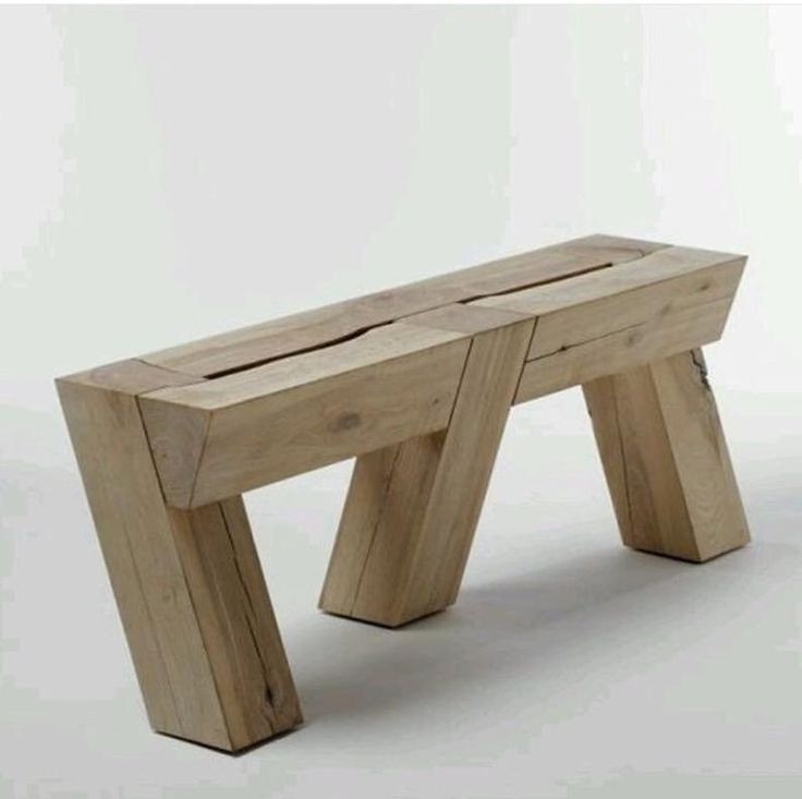 a wooden bench sitting on top of a white floor