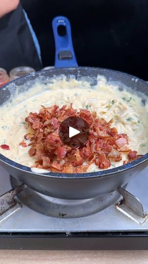 a pan filled with food sitting on top of a stove