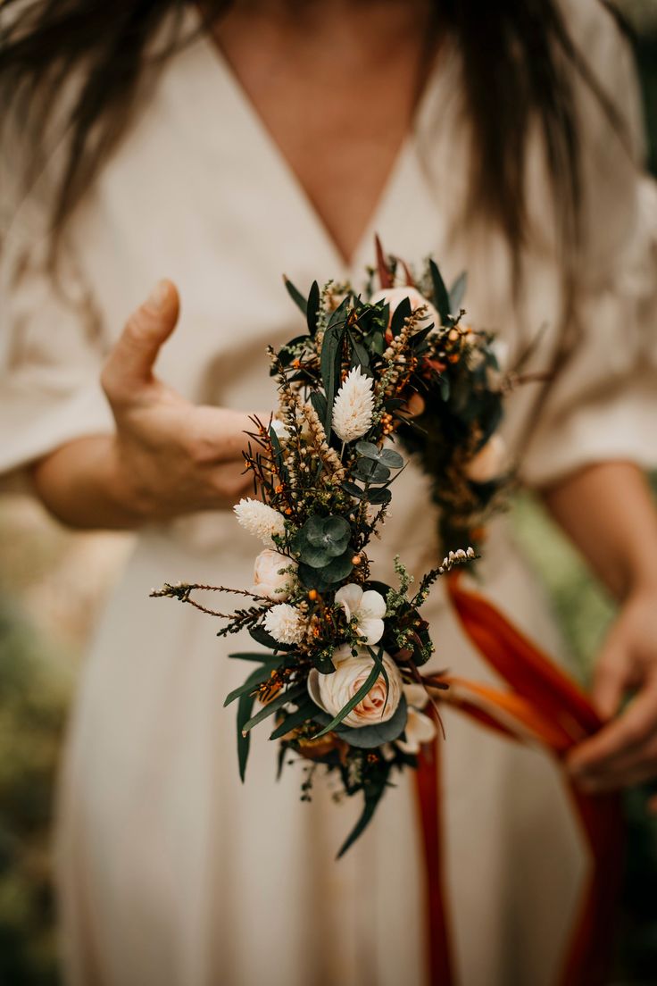 a woman holding flowers in her hands