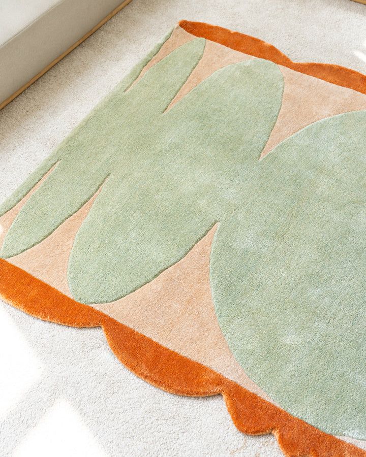 an orange and green rug on the floor