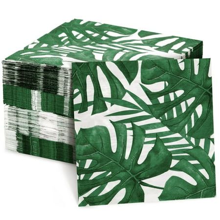 two green and white napkins with palm leaves on the front, one is folded in half