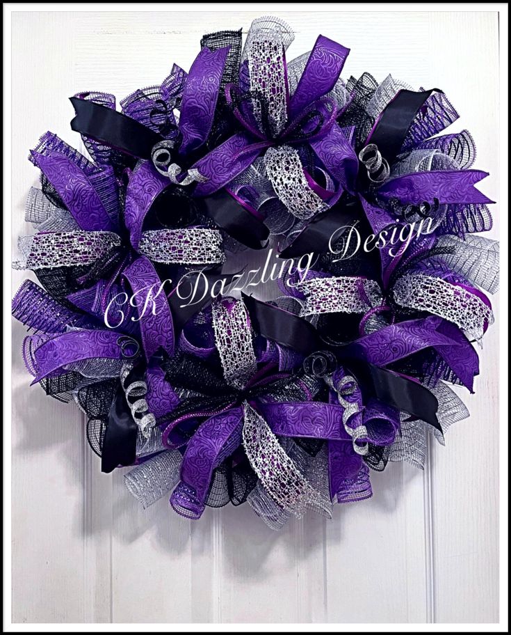 a purple and black mesh wreath on a door