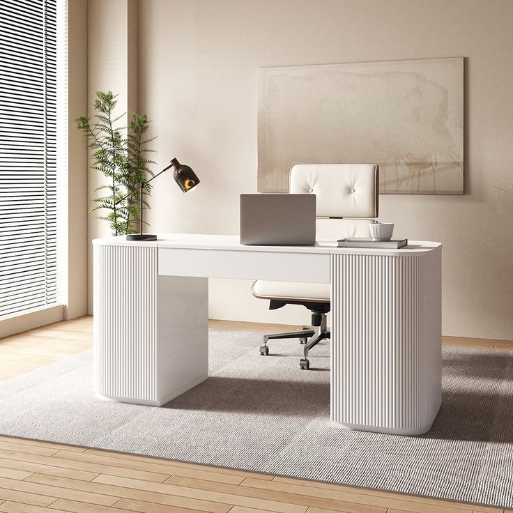 a white desk with a laptop on it in an office space next to a window