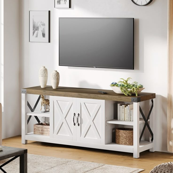 a flat screen tv mounted to the side of a white entertainment center in a living room