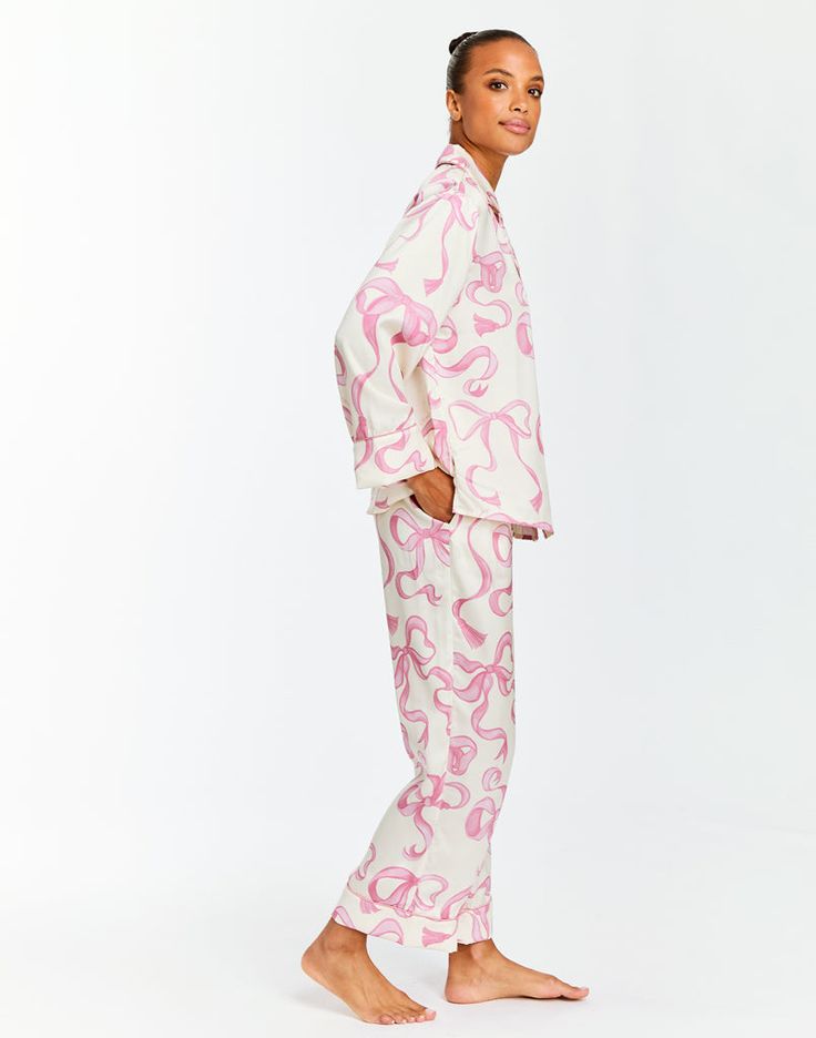 Shirt and pant pajama set in a printed stretch sateen blend Hand-painted bow print with coordinated piping details at lapels and cuffs Elastic waistband in pant for comfort Hand pockets in pant side seam Crafted in machine-washable and wrinkle-free fabric 98% Polyester, 2% Spandex Wash instructions: Machine washable Model is 5’9.5” and wears a size S Monogrammed Pajamas, Bow Print, Bow Pattern, Free Fabric, Shirt And Pants, Angelina Jolie, Wrinkle Free, Mozambique, Pajamas Women