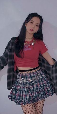 a girl in a red shirt and plaid skirt