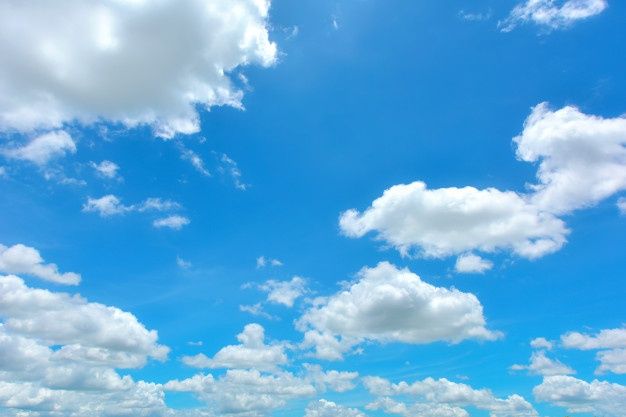 the sky is filled with white clouds and blue water