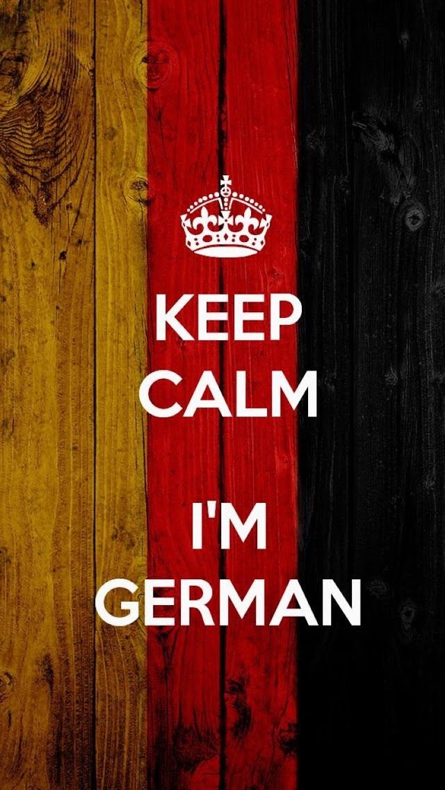 a wooden wall with the words keep calm i'm german