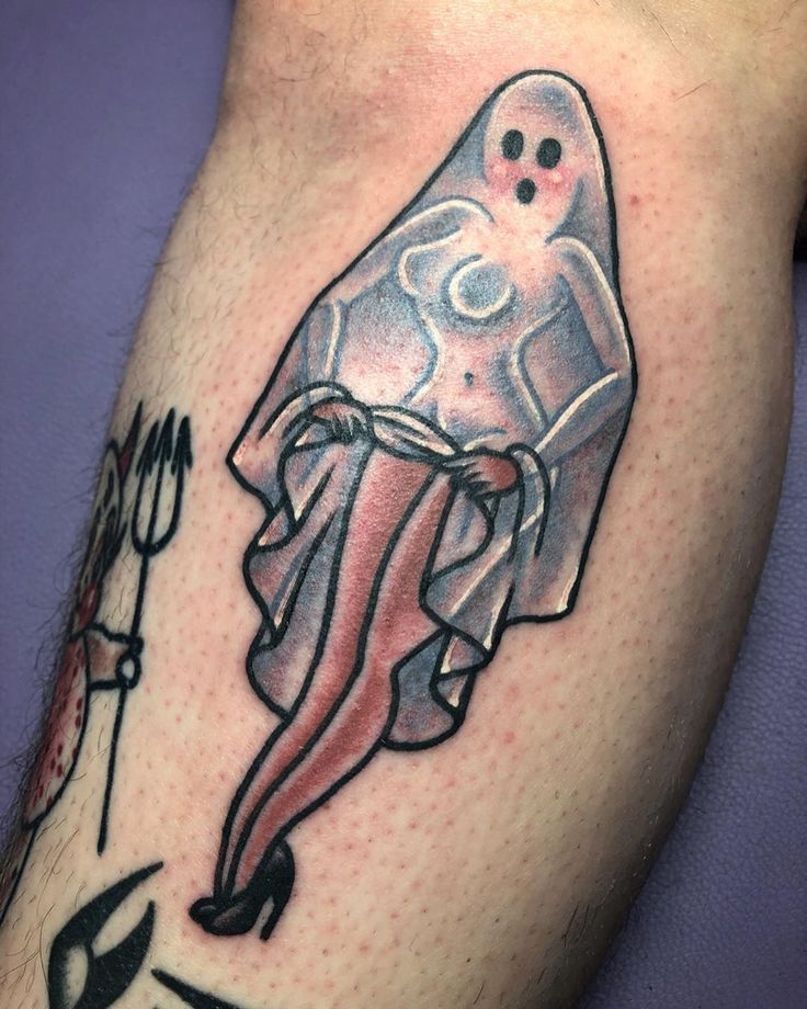 a person with a ghost tattoo on their leg