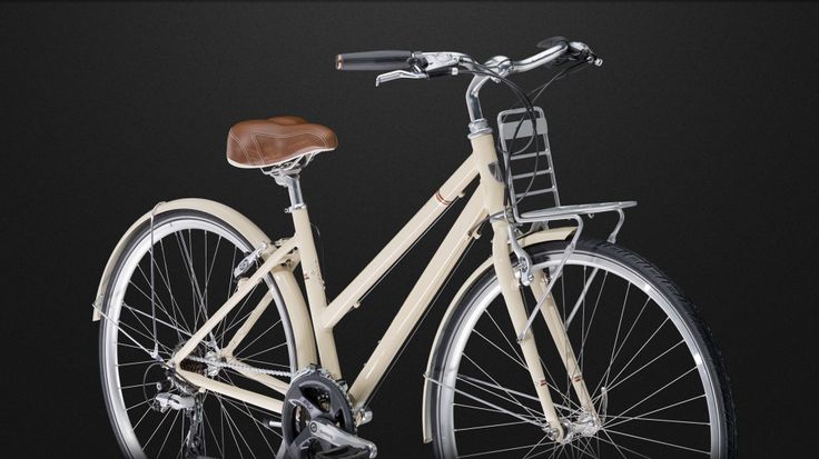 a white bicycle with brown seat and handlebars in front of a black background