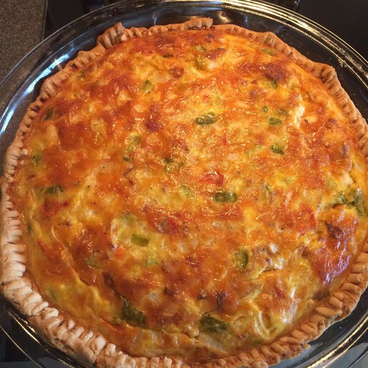 a quiche pie sitting on top of a metal pan