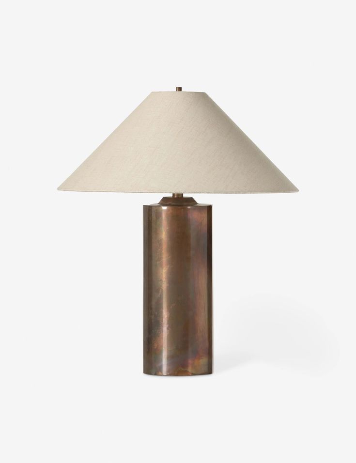 a table lamp with a white shade on top of it and a brown metal base