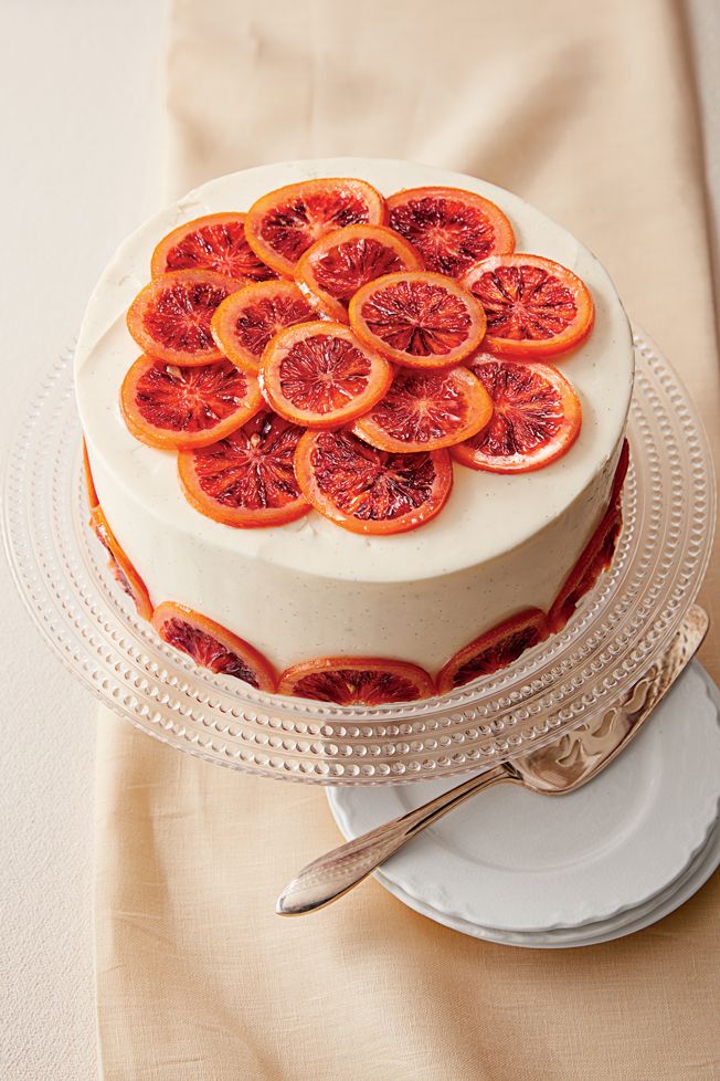 a white cake with blood orange slices on top