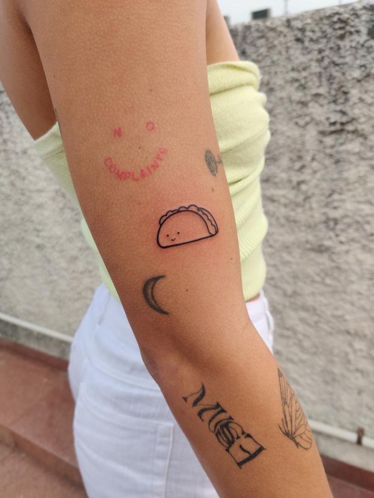 a woman with a taco on her arm and the word love is written across it