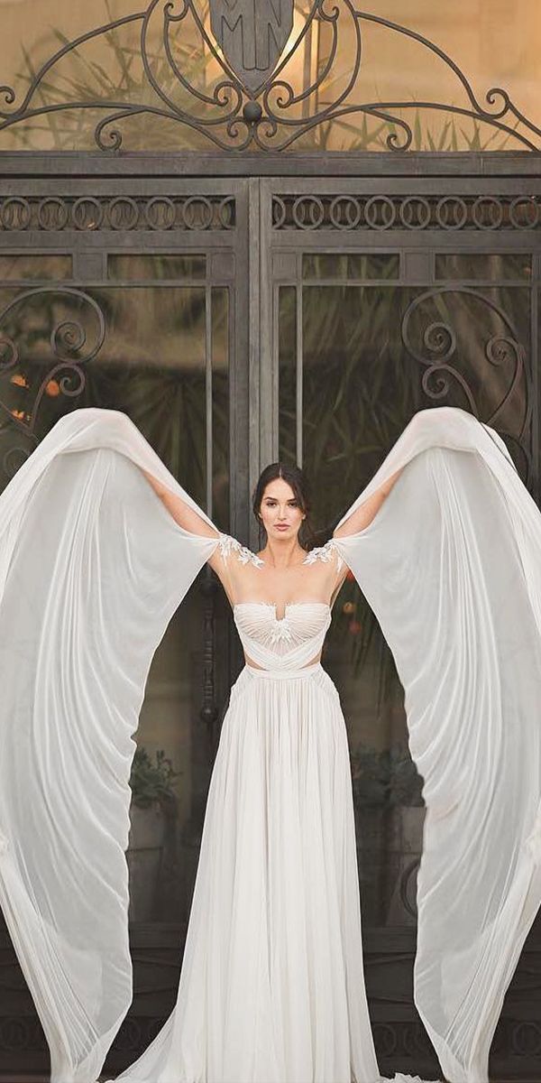 a woman in a white dress with wings