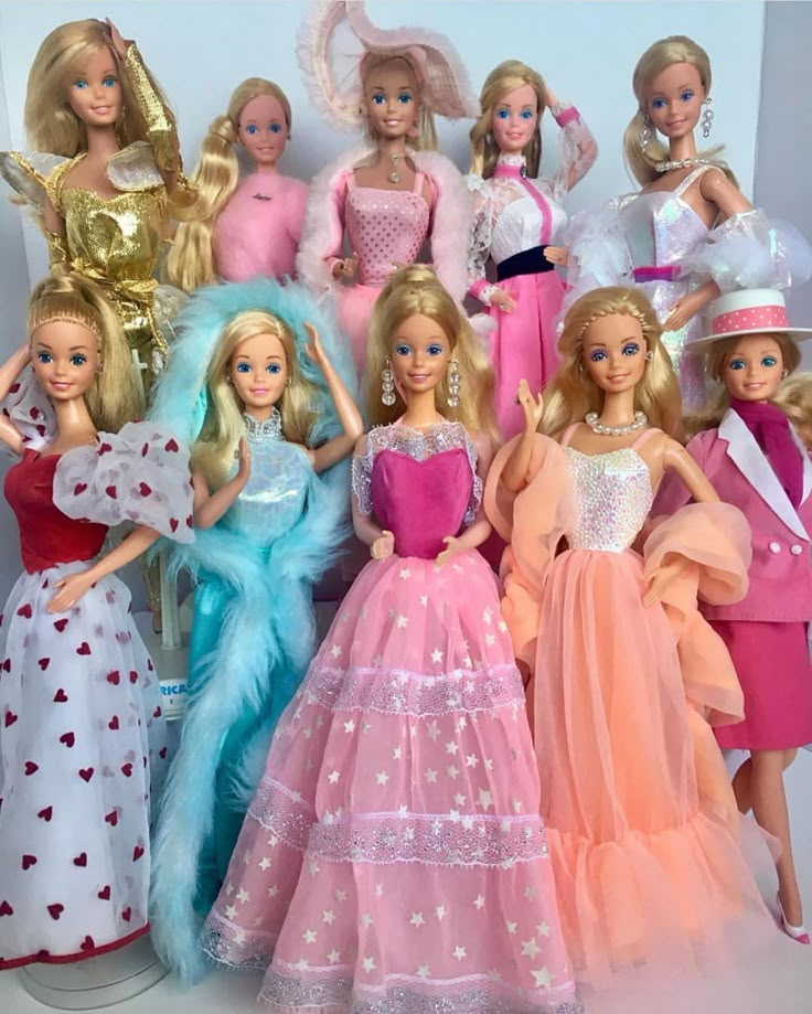 a group of barbie dolls standing next to each other