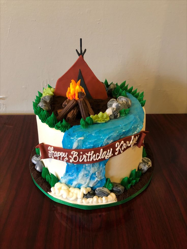 a birthday cake with a tent and campfire on it