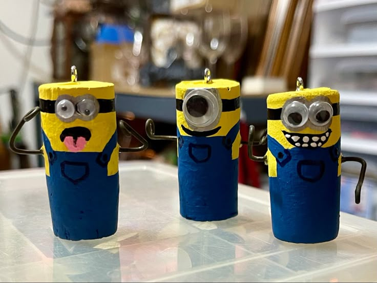 three minion candles sitting on top of a table