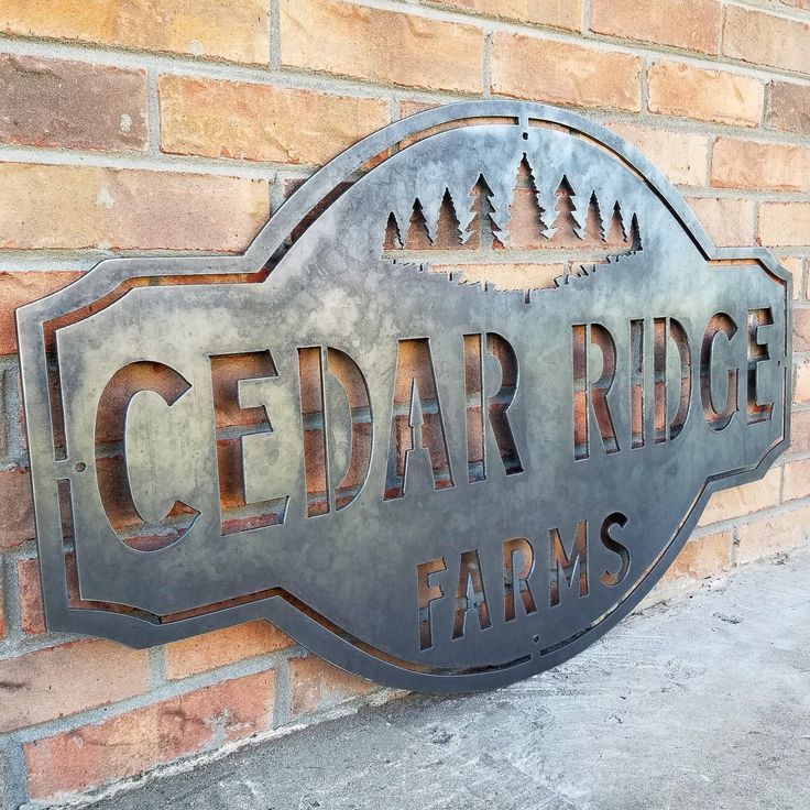 a sign on the side of a brick building that says cedar ridge farms and pine trees