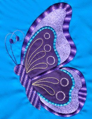 a purple and blue butterfly is on a blue background, with gold threadwork in the center