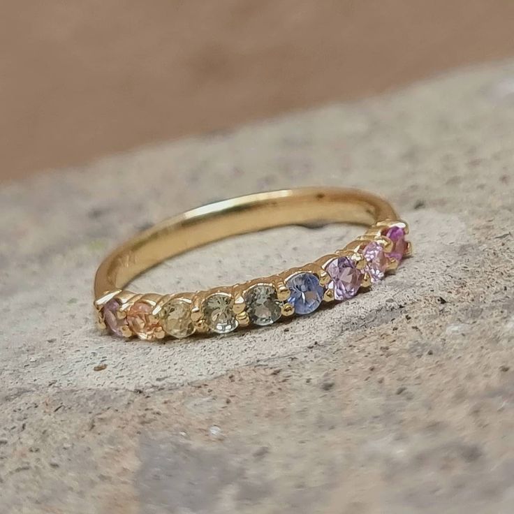 ✨💎 Beautiful mid eternity pastel rainbow ring Perfect ring, with seamless fit and comfort .... Details .... Made to order, with love ♥ Marked 14k solid Gold ♥ Ring width: 2.5mm ♥ Gemstone: 100% natural sapphires ♥ Shape And Cut: Brilliant round, Excellent quality ♥ Gem size: 2.5mm PROCESSING & SHIPPING *We offer shipping worldwide! *All items are fully insured and traceable online *The ring comes nicely packed in velvet ring box and lovely note Feel free to contact us for extra photographs, cheerfully provided 😇 Rainbow Engagement Rings, Pastel Rings, Rainbow Wedding Ring, Colourful Wedding Band, Colorful Wedding Band, Rainbow Ring, Rainbow Wedding Band, Ethereal Jewelry, Sapphire Eternity Band