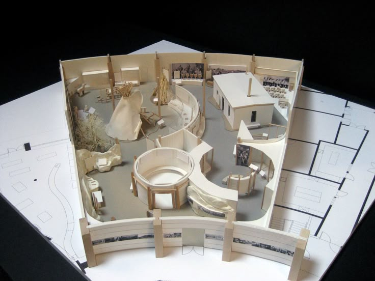 an aerial view of a model house on top of blueprints