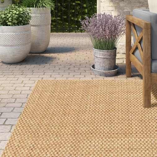 an outdoor area with two chairs and potted plants