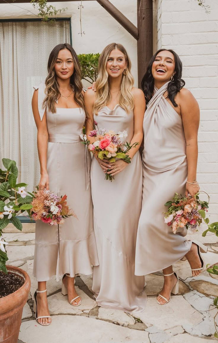 three bridesmaids standing in front of a house