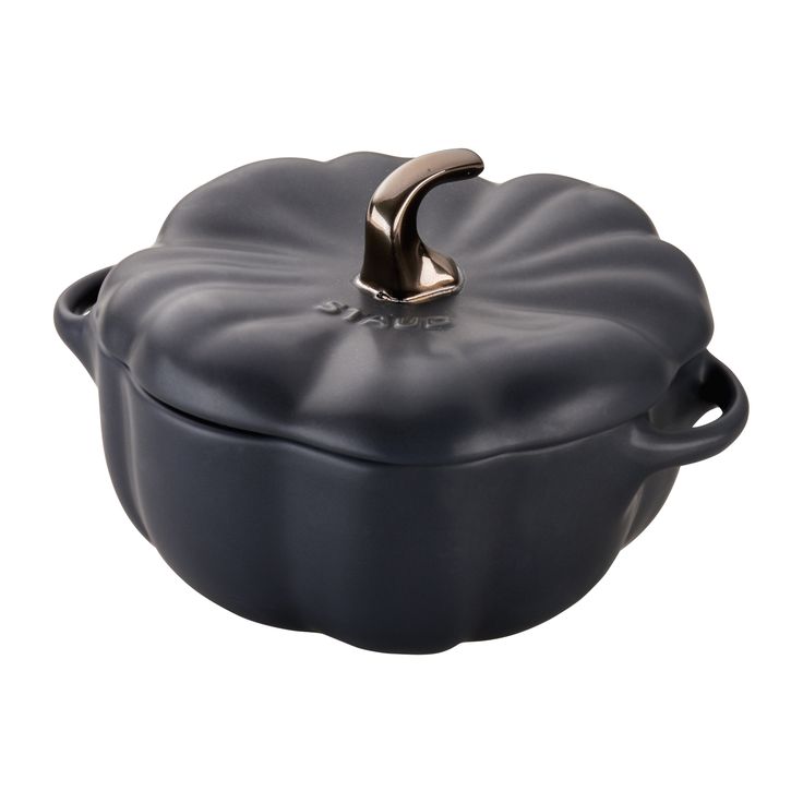 a black casserole dish with a gold handle on the top and an open lid