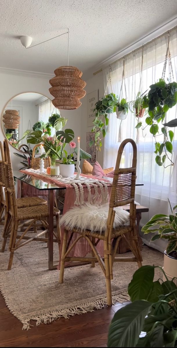 a dining room table with chairs and plants in the window sill, along with a rug on the floor