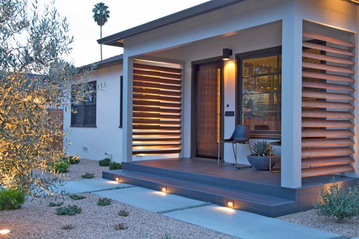 a small house with lights on the front porch