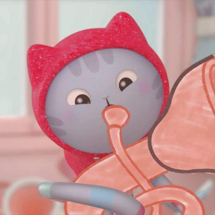 a cartoon cat with a pink pacifier sticking out of it's mouth and wearing a red hat