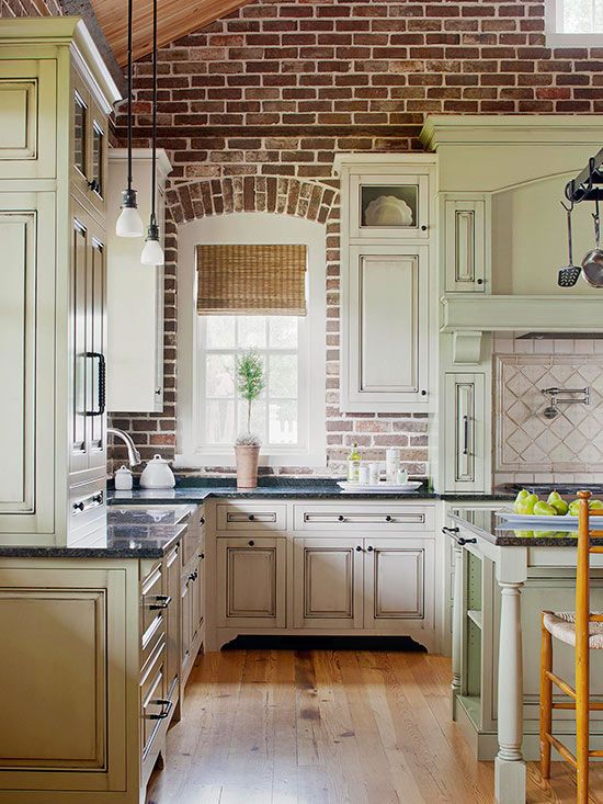 a kitchen with wooden floors and white cabinets